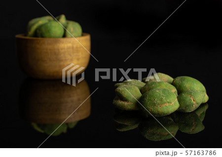 Green wasabi peanut isolated on black glass Green wasabi peanut isolated on black glass 57163786