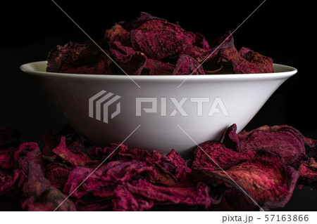 Dried red beetroot isolated on black glass 57163866