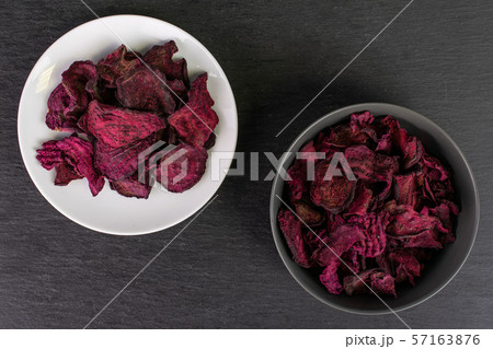 Dried red beetroot on grey stone Dried red beetroot on grey stone 57163876