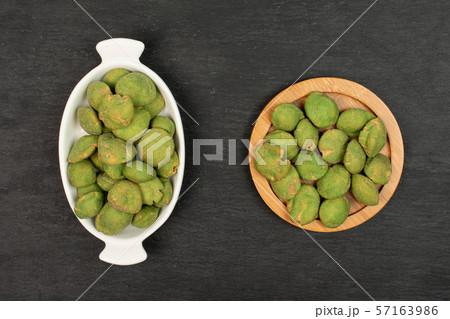 Green wasabi peanut on grey stone 57163986