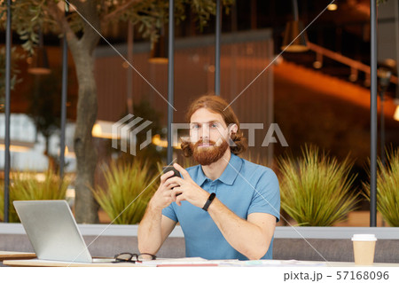 Man using phone in cafe Man using phone in cafe 57168096