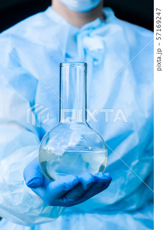 laboratory flask with a liquid in a researcher’s laboratory flask with a liquid in a researcher’s 57169247