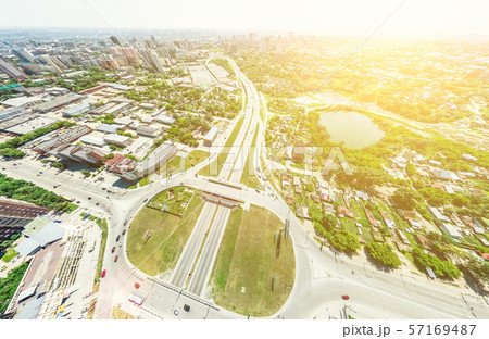 Aerial city view with crossroads and roads, houses, buildings, parks and parking lots. Sunny summer 57169487