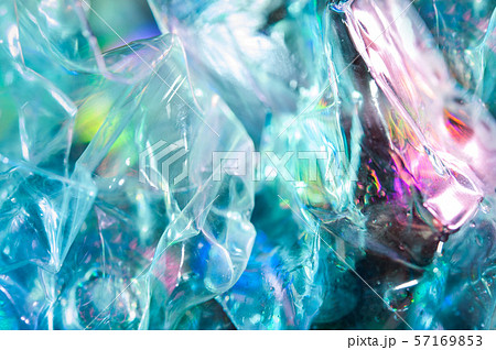 Holographic background in the style of the 80-90s. Real texture of cellophane film in bright acid 57169853