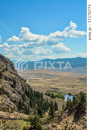 Scenery view of a valley with small lake downhill on bright sunny day 57170774