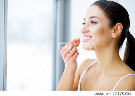Beautiful Woman Holding Fish Oil Pill In Hand. Healthy Nutrition 57170859