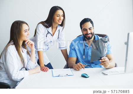 Health Care. Medical Team Examining X-ray Report in Corridor. Medical Concept Health Care. Medical Team Examining X-ray Report in Corridor. Medical Concept 57170885