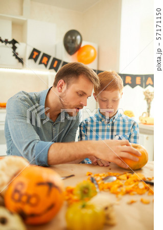Family of two working with pumpkin 57171150