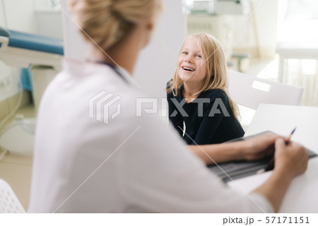 Cute smiling kid girl with blond hair at pediatrician appointment Cute smiling kid girl with blond hair at pediatrician appointment 57171151