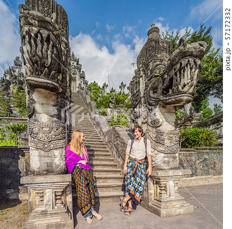 Happy couple of tourists on background of Three stone ladders in beautiful Pura Lempuyang Luhur 57172332