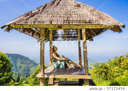 Young woman in traditional balinese gazebo. Bali island 57172454