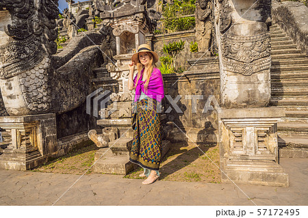 Young woman tourist on background of Three stone ladders in beautiful Pura Lempuyang Luhur temple 57172495