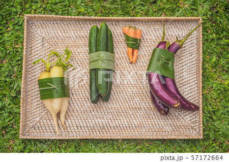 Eco-friendly product packaging concept. Vegetables wrapped in a banana leaf, as an alternative to a 57172664