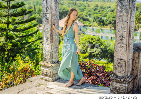 Young woman in dress in Water Palace Soekasada Taman Ujung Ruins on Bali Island in Indonesia 57172735