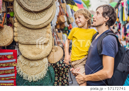 Dad and son at a market in Ubud, Bali. Typical souvenir shop selling souvenirs and handicrafts of 57172741