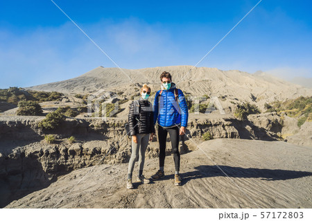 Young couple man and woman visit the Bromo volcano at the Tengger Semeru National Park on Java 57172803