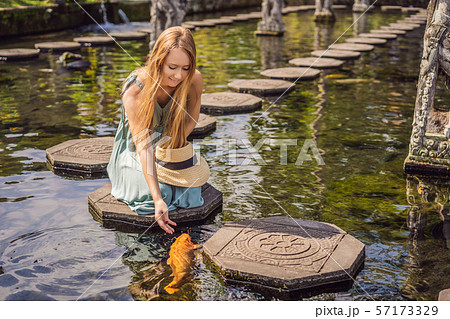 Young woman tourist in Taman Tirtagangga, Water palace, Water park, Bali Indonesia Young woman tourist in Taman Tirtagangga, Water palace, Water park, Bali Indonesia 57173329