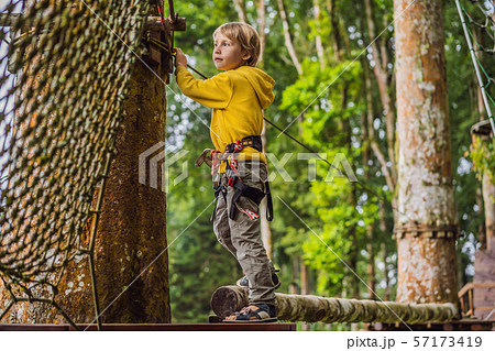 Little boy in a rope park. Active physical recreation of the child in the fresh air in the park 57173419