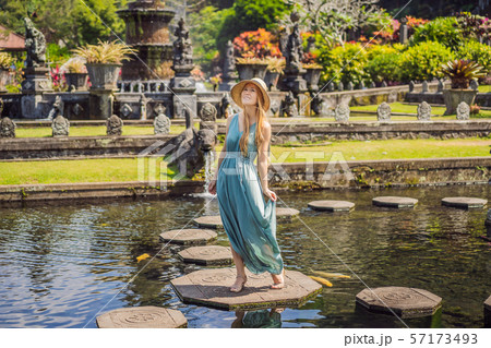 Young woman tourist in Taman Tirtagangga, Water palace, Water park, Bali Indonesia 57173493