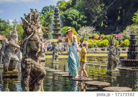 Mom and son tourists in Taman Tirtagangga, Water palace, Water park, Bali Indonesia. Traveling with 57173582