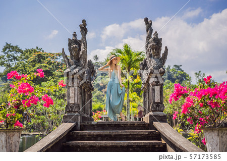 Young woman tourist in Taman Tirtagangga, Water palace, Water park, Bali Indonesia 57173585