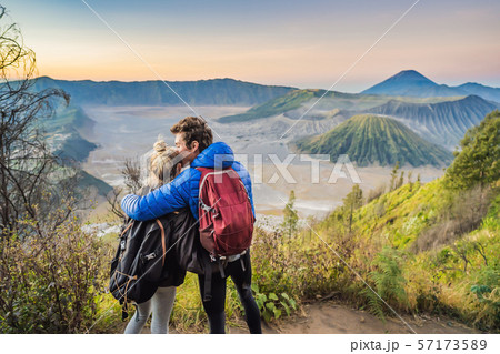 Young couple man and woman meet the sunrise at the Bromo Tengger Semeru National Park on the Java Young couple man and woman meet the sunrise at the Bromo Tengger Semeru National Park on the Java 57173589
