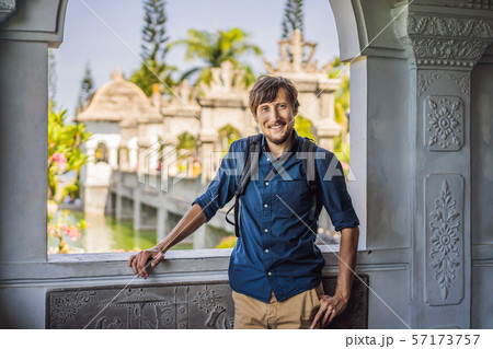 Young man in Water Palace Soekasada Taman Ujung Ruins on Bali Island in Indonesia. Amazing old 57173757