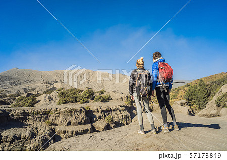 Young couple man and woman visit the Bromo volcano at the Tengger Semeru National Park on Java 57173849