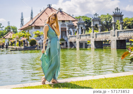 Young woman in dress in Water Palace Soekasada Taman Ujung Ruins on Bali Island in Indonesia 57173852
