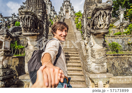 follow me photo. Young man tourist on background of Three stone ladders in beautiful Pura Lempuyang 57173899