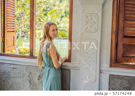Young woman in dress in Water Palace Soekasada Taman Ujung Ruins on Bali Island in Indonesia 57174249