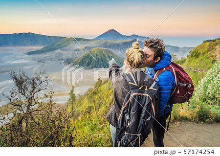 Young couple man and woman meet the sunrise at the Bromo Tengger Semeru National Park on the Java 57174254