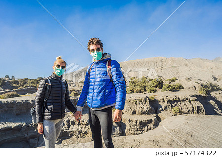 Young couple man and woman visit the Bromo volcano at the Tengger Semeru National Park on Java Young couple man and woman visit the Bromo volcano at the Tengger Semeru National Park on Java 57174322
