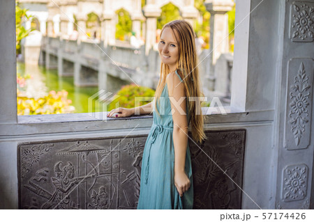 Young woman in dress in Water Palace Soekasada Taman Ujung Ruins on Bali Island in Indonesia Young woman in dress in Water Palace Soekasada Taman Ujung Ruins on Bali Island in Indonesia 57174426