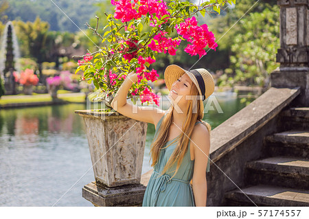 Young woman tourist in Taman Tirtagangga, Water palace, Water park, Bali Indonesia 57174557