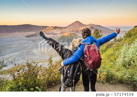 Young couple man and woman meet the sunrise at the Bromo Tengger Semeru National Park on the Java 57174559