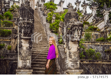 Young woman tourist on background of Three stone ladders in beautiful Pura Lempuyang Luhur temple 57174575