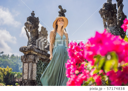 Young woman tourist in Taman Tirtagangga, Water palace, Water park, Bali Indonesia 57174838