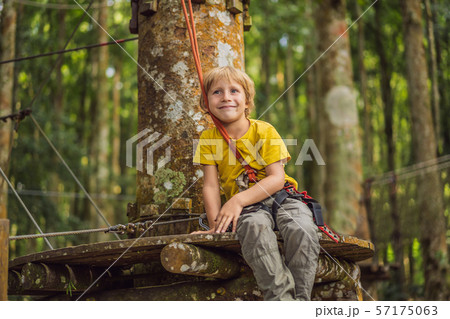 Little boy in a rope park. Active physical recreation of the child in the fresh air in the park Little boy in a rope park. Active physical recreation of the child in the fresh air in the park 57175063