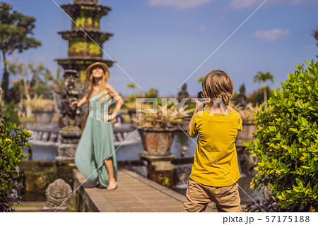 Mom and son tourists in Taman Tirtagangga, Water palace, Water park, Bali Indonesia. Traveling with 57175188