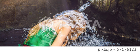 Woman in holy spring water temple in bali. The temple compound consists of a petirtaan or bathing Woman in holy spring water temple in bali. The temple compound consists of a petirtaan or bathing 57176123