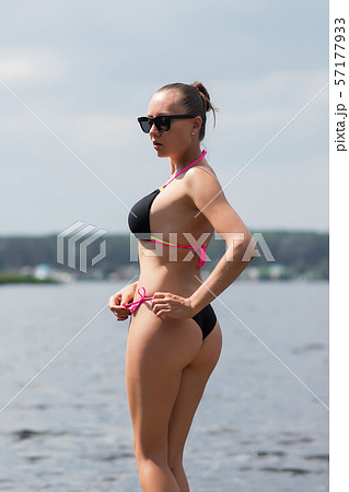 Fit hot woman taking off swimsuit panties Stock Photo