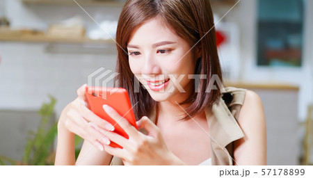 Young woman use mobilephone happily 57178899