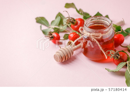 Fresh rose hip berries and honey on pink 57180414