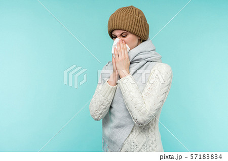 Health and medicine concept - Young woman blowing Health and medicine concept - Young woman blowing 57183834
