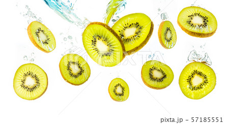 Kiwi slices falling into water and sinking 57185551