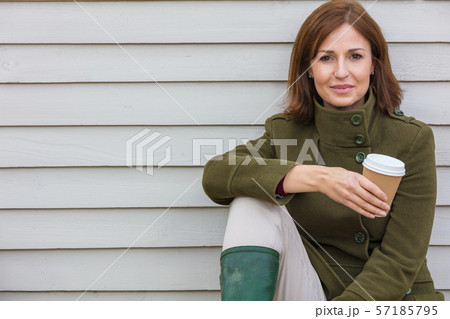 Happy Attractive Middle Aged Woman Drinking Coffee Happy Attractive Middle Aged Woman Drinking Coffee 57185795