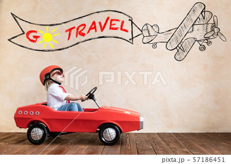 Funny kid driving toy car at home Funny kid driving toy car at home 57186451