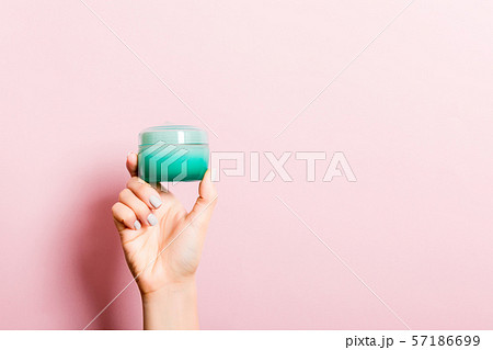 Female hand holding cream bottle of lotion Female hand holding cream bottle of lotion 57186699