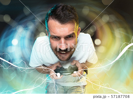 Enthusiastic gamer. Joyful young man holding a video game controller 57187708